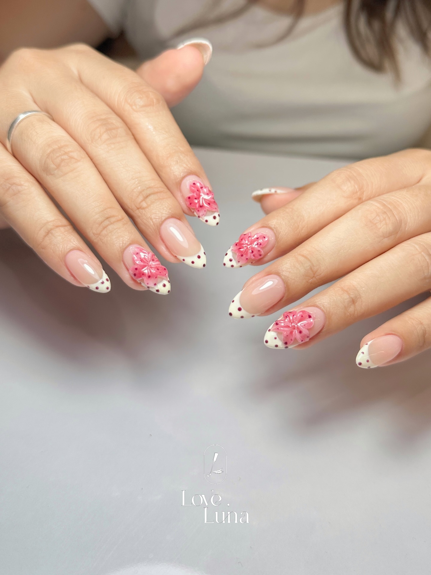 Pink floral nail art with rhinestones