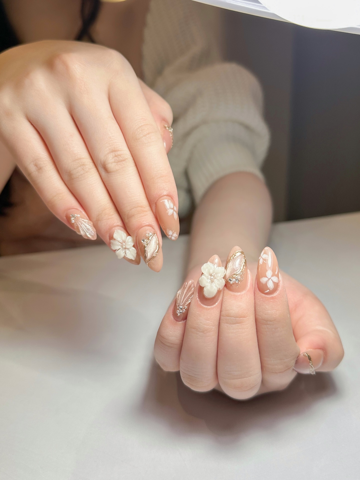 3D white floral nails with gold butterfly accents