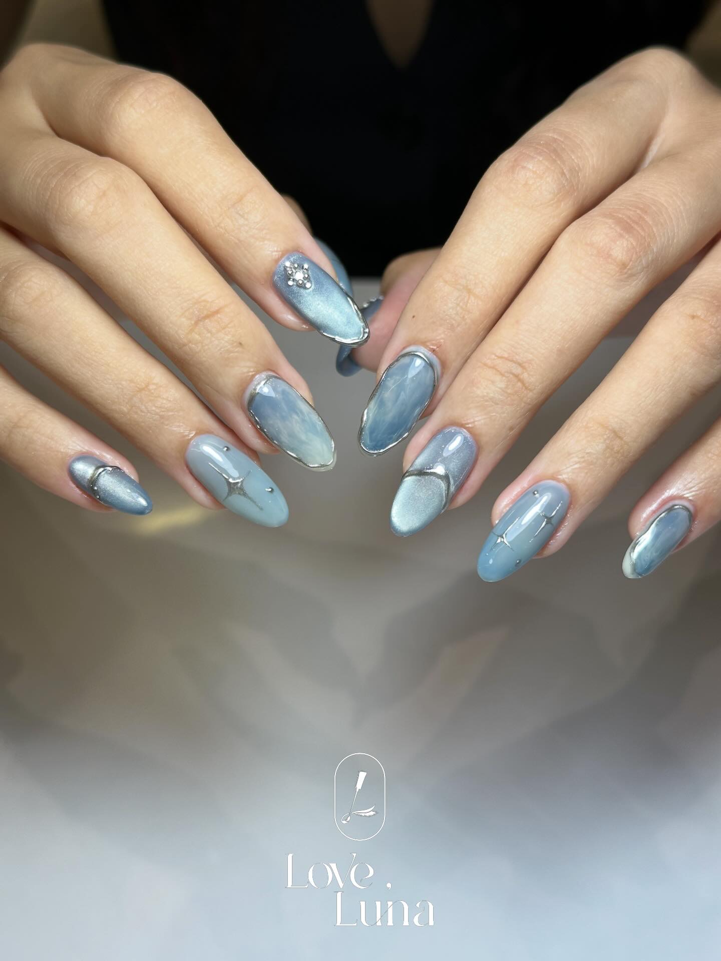 Blue chrome gel nails with silver line detail